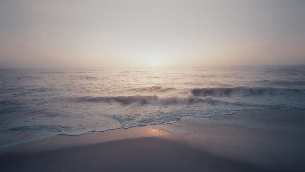 Soft wave rolling onto the shore at dawn